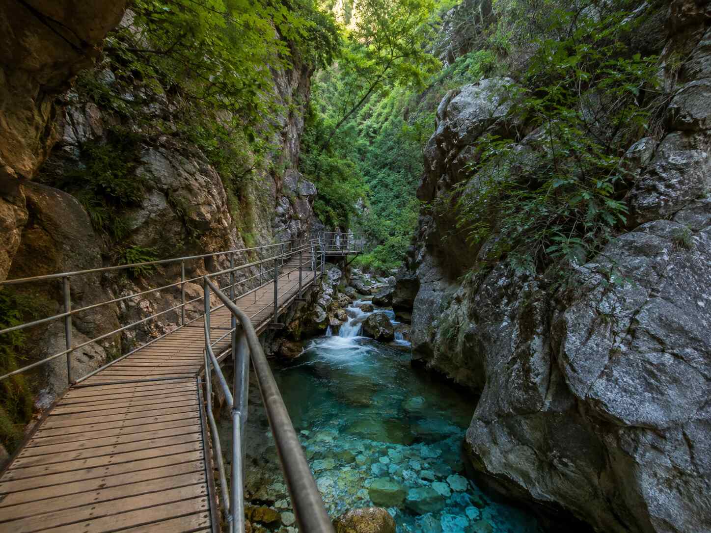 Wooden boardwalk following the turquoise stream through Sapadere Canyon near Alanya