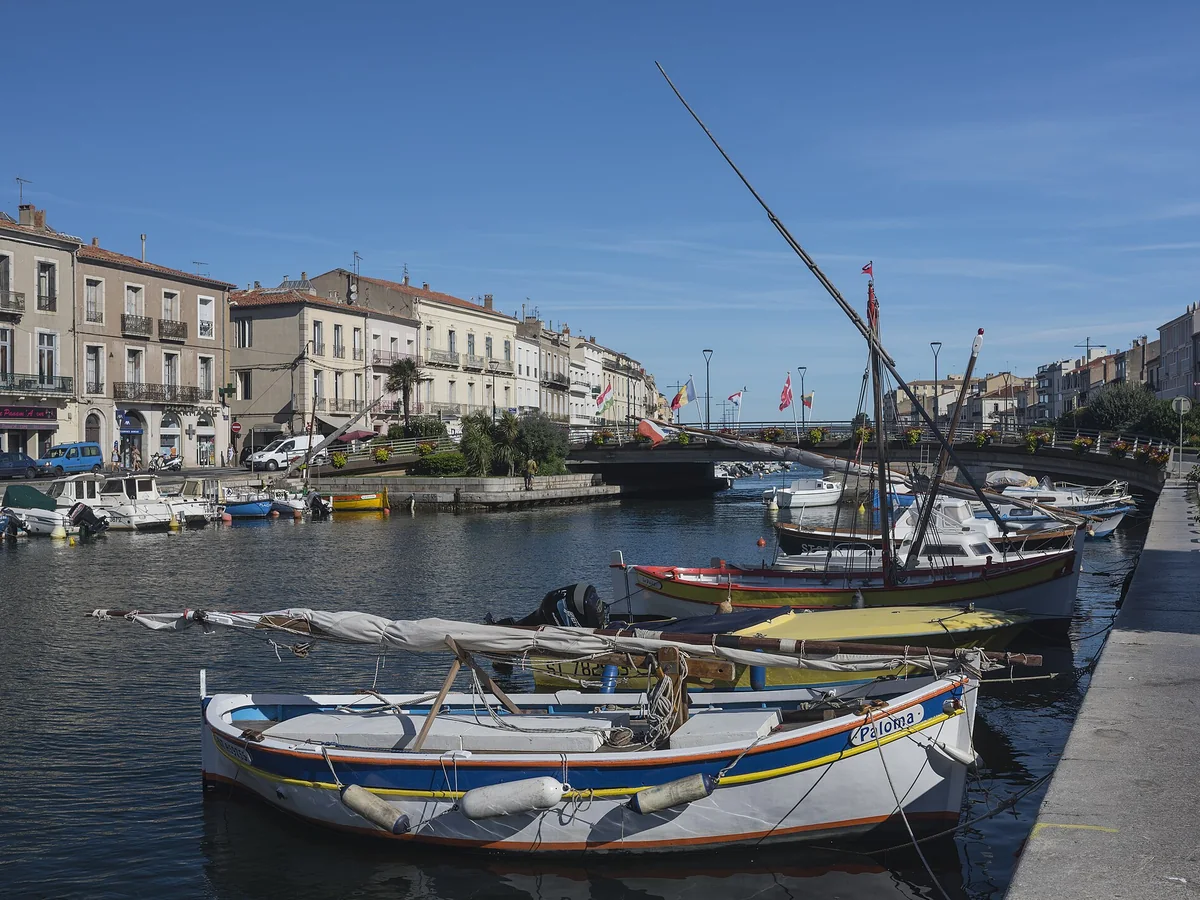 Colorful boats moored along the Canal de Sète in the city center