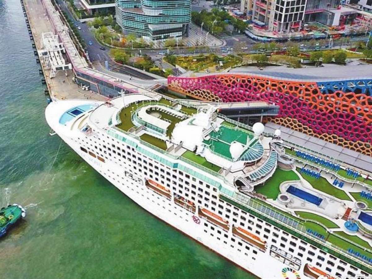 Cruise ship docked beside the colorful Shekou Cruise Home Port terminal in Shenzhen