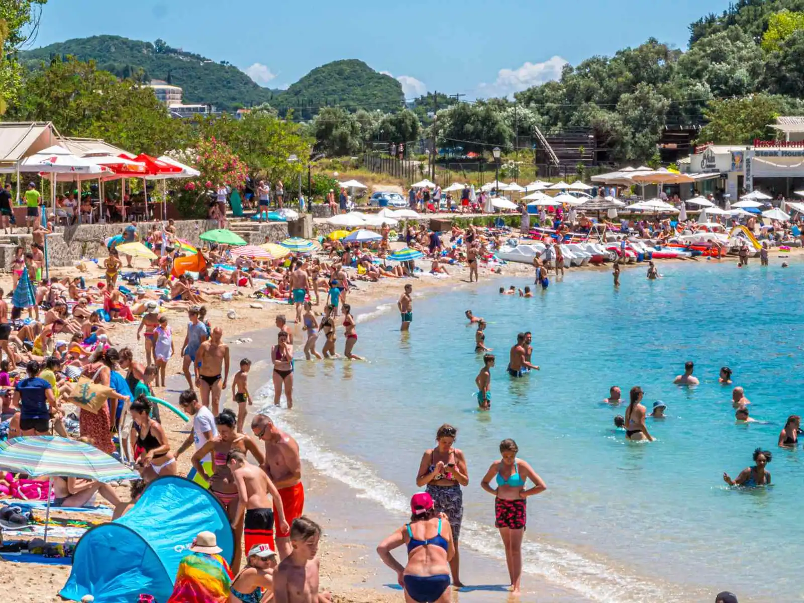 Crowded Mediterranean beach on a busy summer day