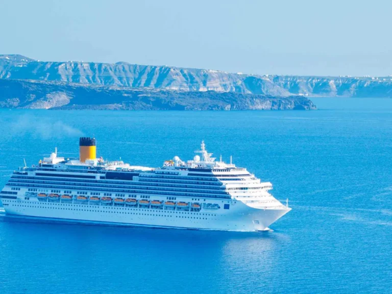 Cruise ship sailing across the blue Santorini caldera