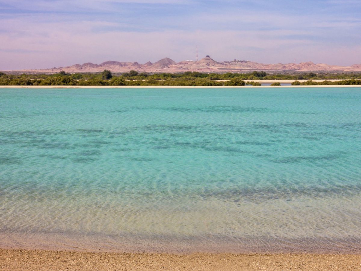 Shallow turquoise lagoon and desert hills on Sir Bani Yas Island