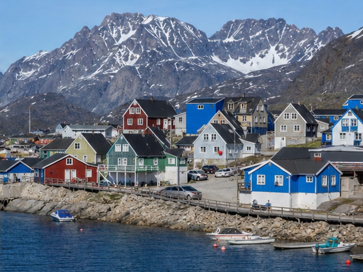 Colorful waterfront houses and mountains in Sisimiut, Greenland