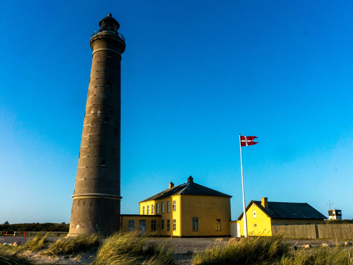 Grey Lighthouse and adjacent yellow buildings near Grenen in Skagen