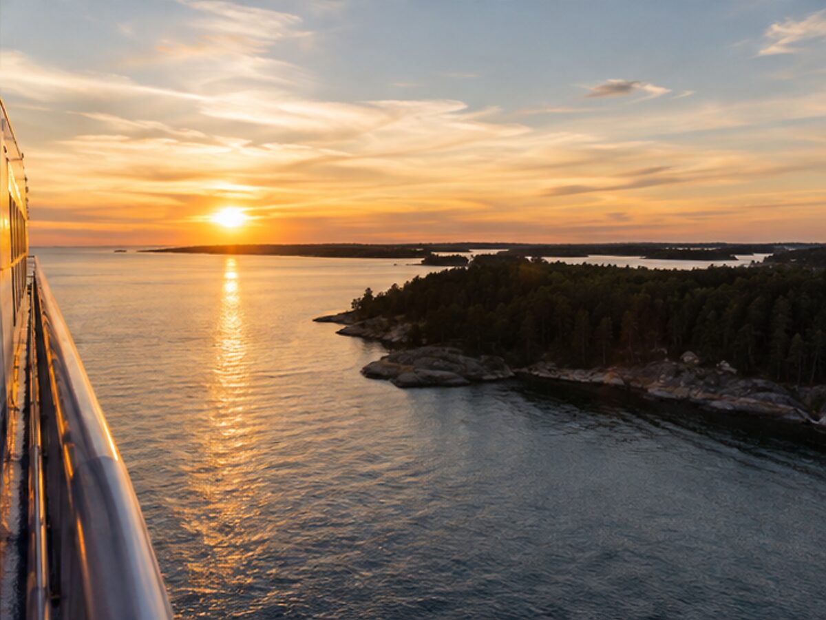 Sunset over wooded skerries during a Baltic ferry departure from Stockholm