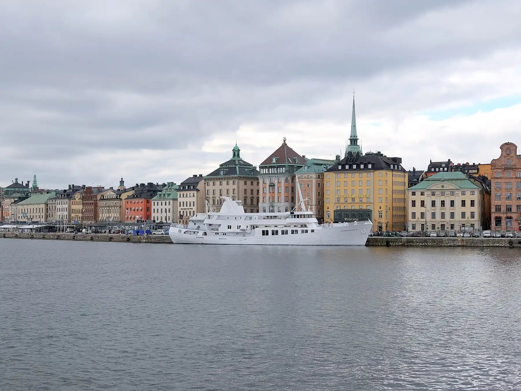 Boats and historic buildings along Stockholm's Gamla Stan waterfront.