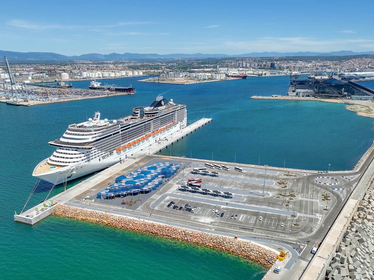 Aerial view of a cruise ship at Tarragona terminal with the commercial port behind