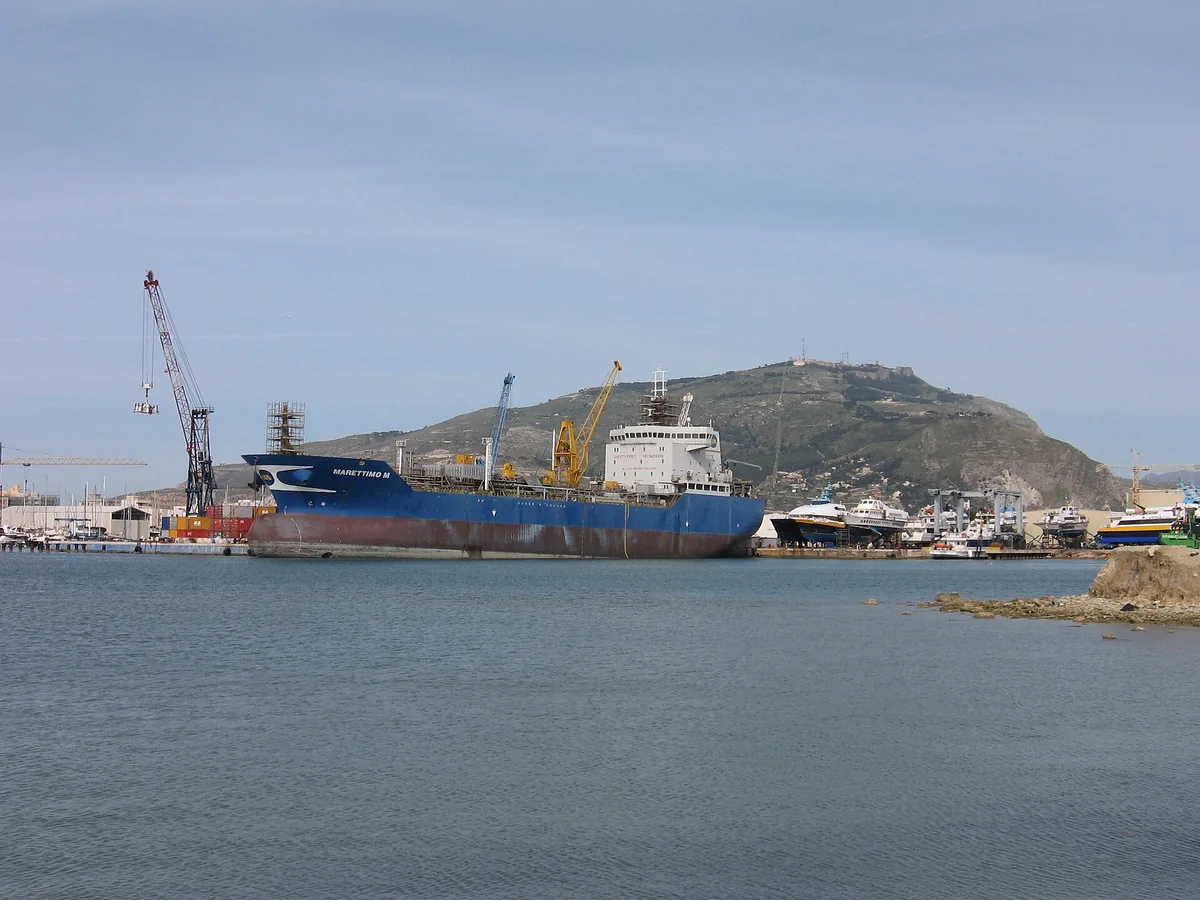 Commercial ship and port cranes in Trapani Harbour