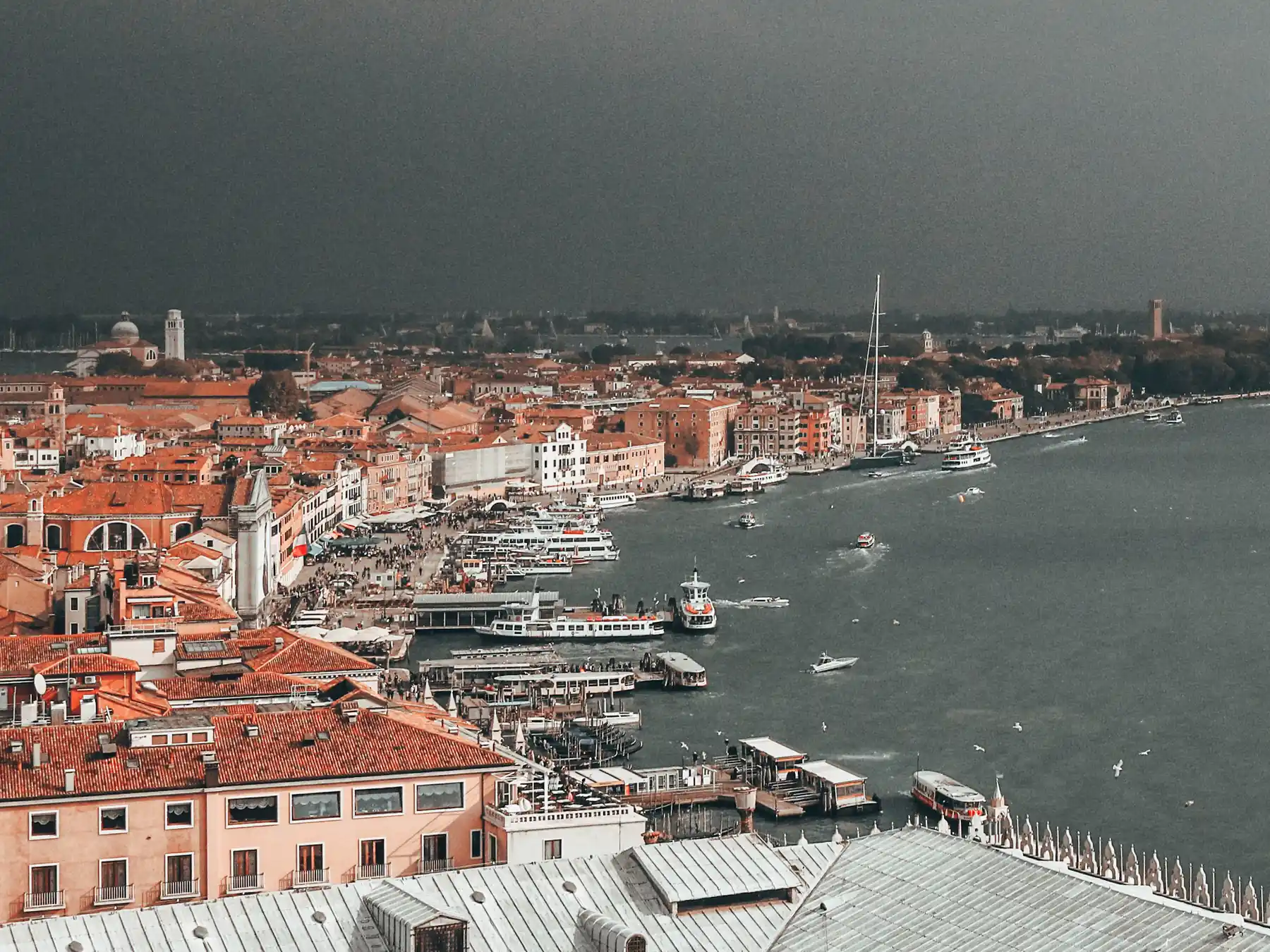 Aerial view of Venice's Riva degli Schiavoni waterfront and boats on the lagoon.