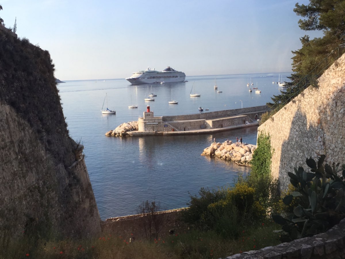 Cruise ship anchored beyond the harbor walls at Villefranche-sur-Mer