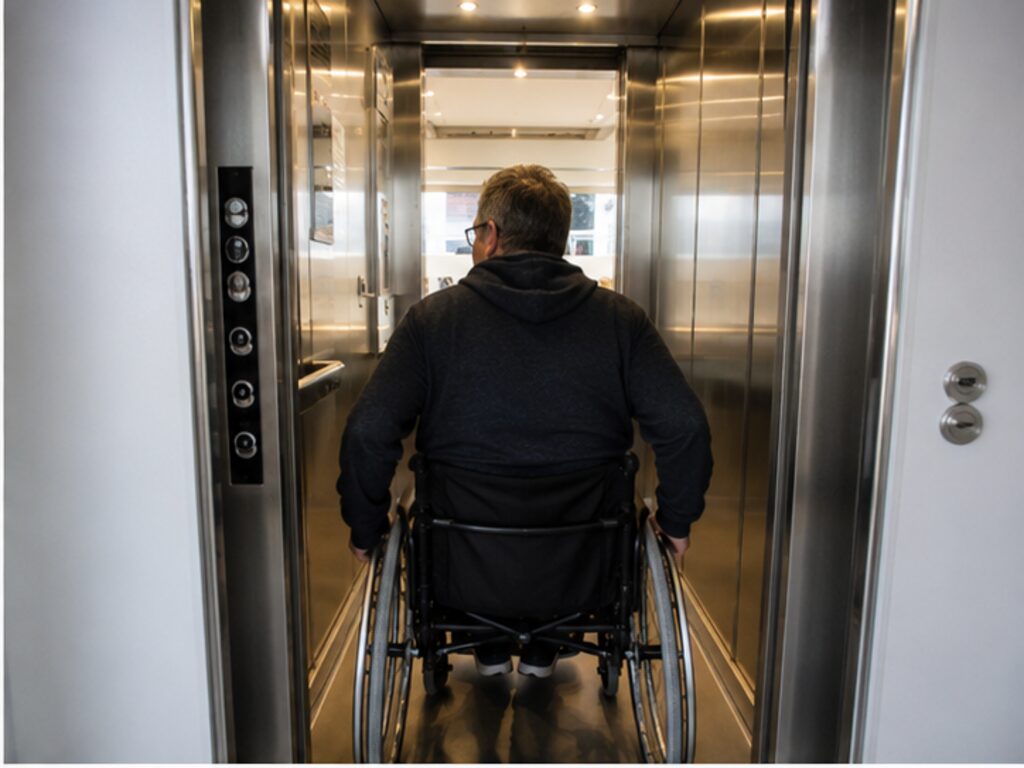 Wheelchair user entering a compact elevator aboard a river cruise ship