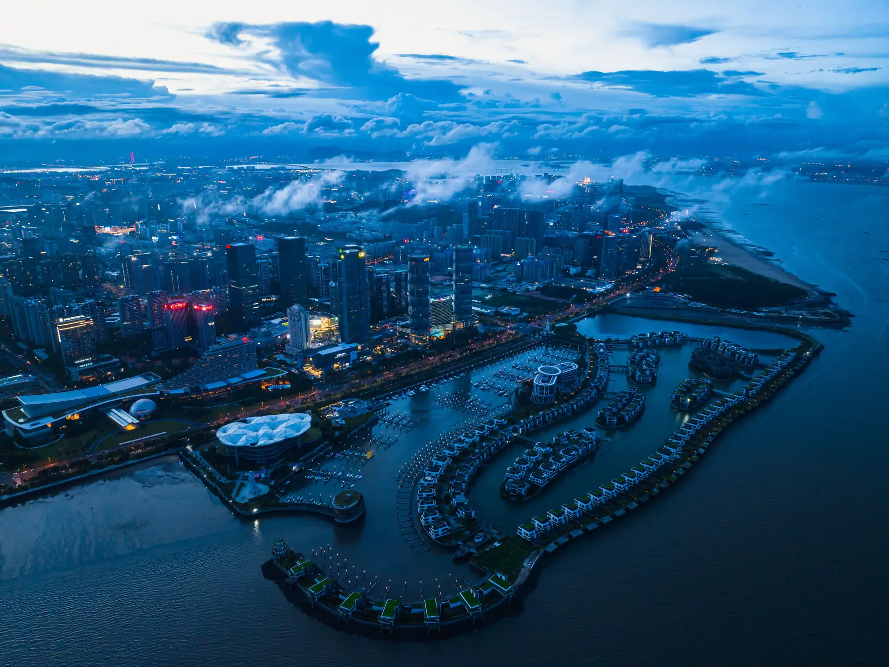 Aerial view of Xiamen marina and waterfront skyscrapers at dusk