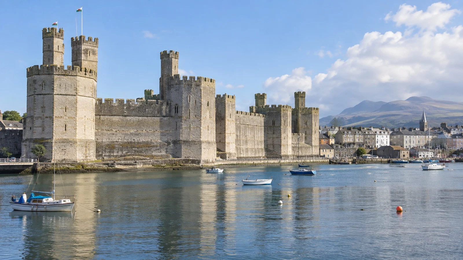 Caernarfon Castle in North Wales beside the Menai Strait.