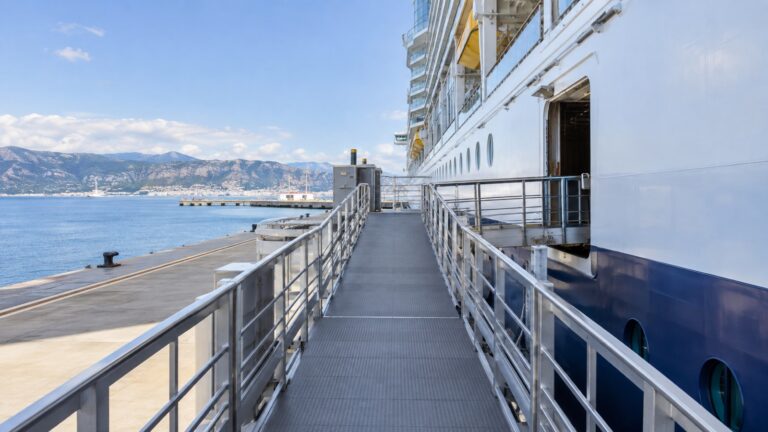 Empty wide cruise ship gangway at a modern pier with gentle slope