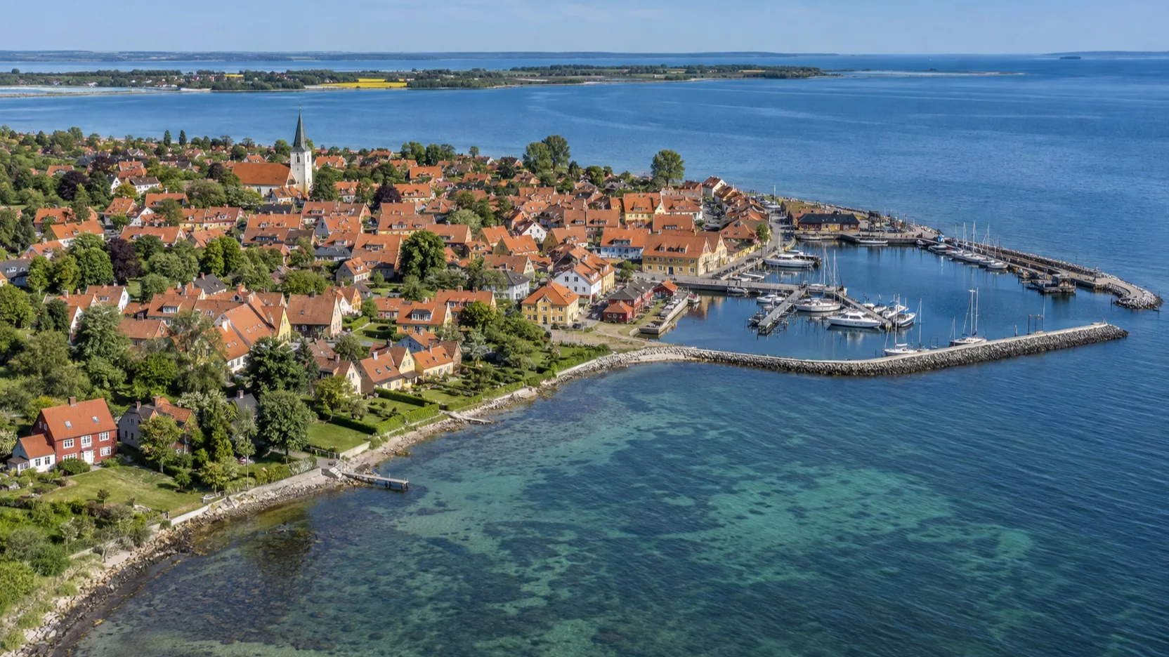 Aerial view of Ærøskøbing red rooftops, marina, and Baltic coastline