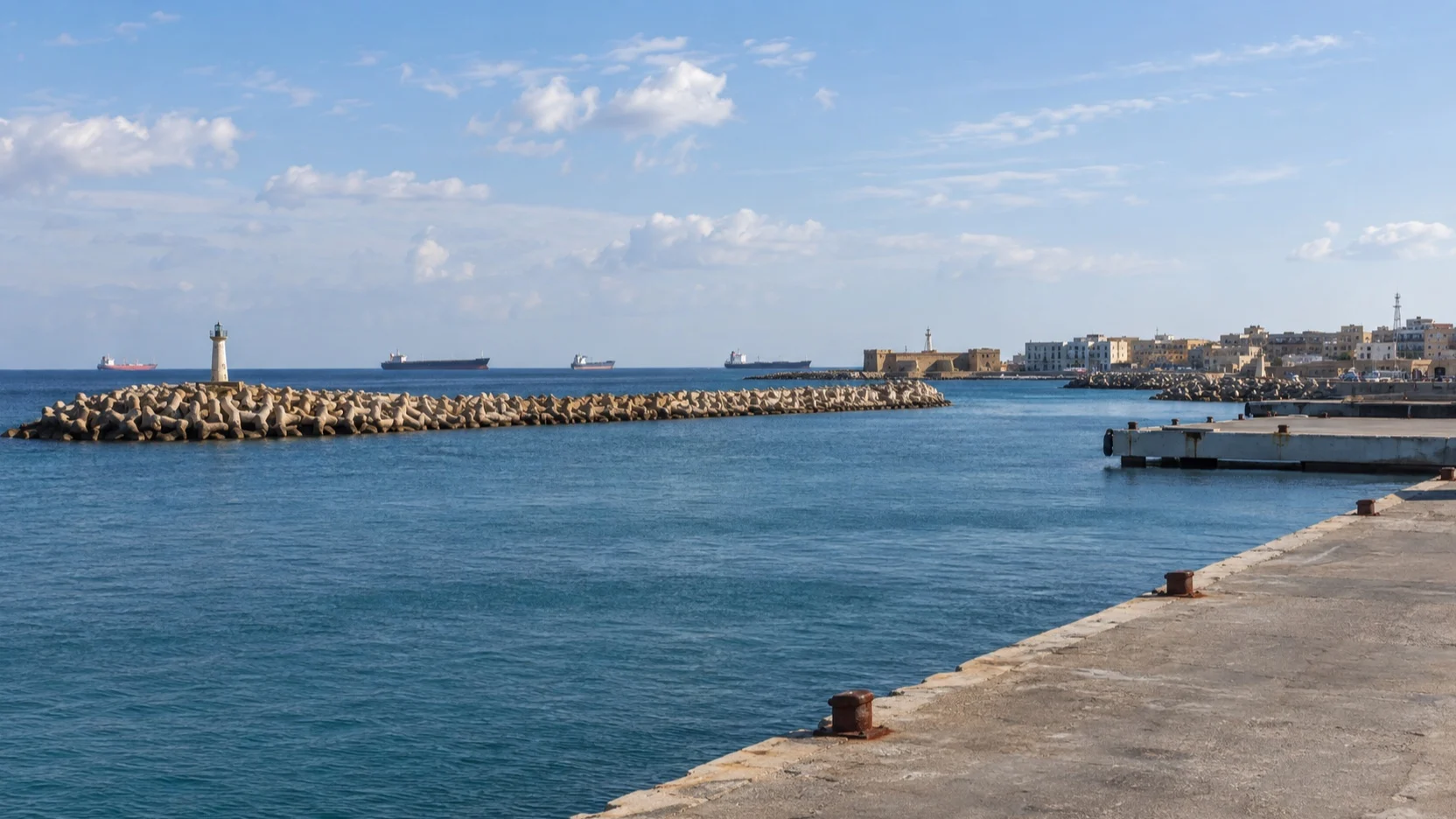 Empty harbor quay and breakwater at Al Khoms, Libya