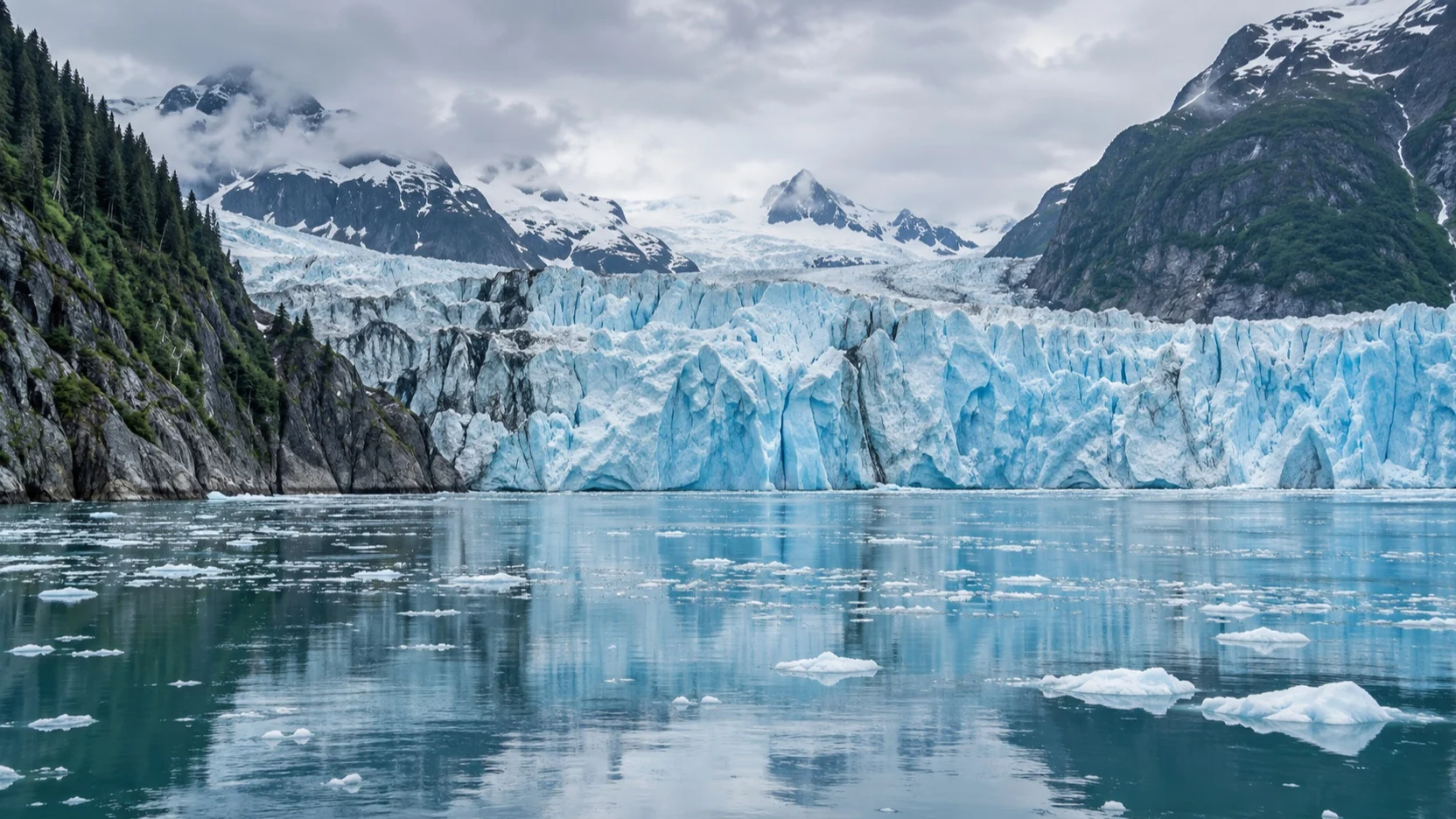 Blue tidewater glacier and floating ice in an Alaska fjord