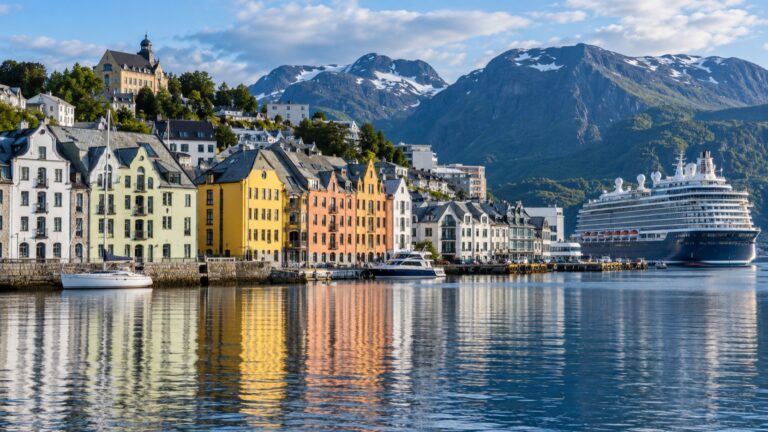 A cruise ship beside colorful Art Nouveau buildings in Ålesund harbor