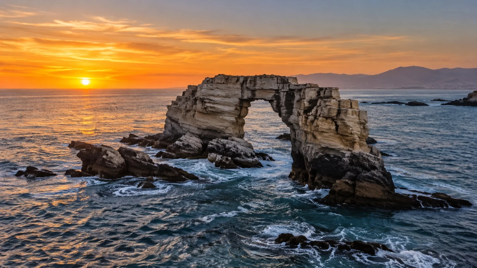 La Portada natural stone arch rises from the Pacific near Antofagasta