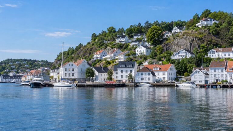 White wooden houses along the harbor in Arendal, Norway