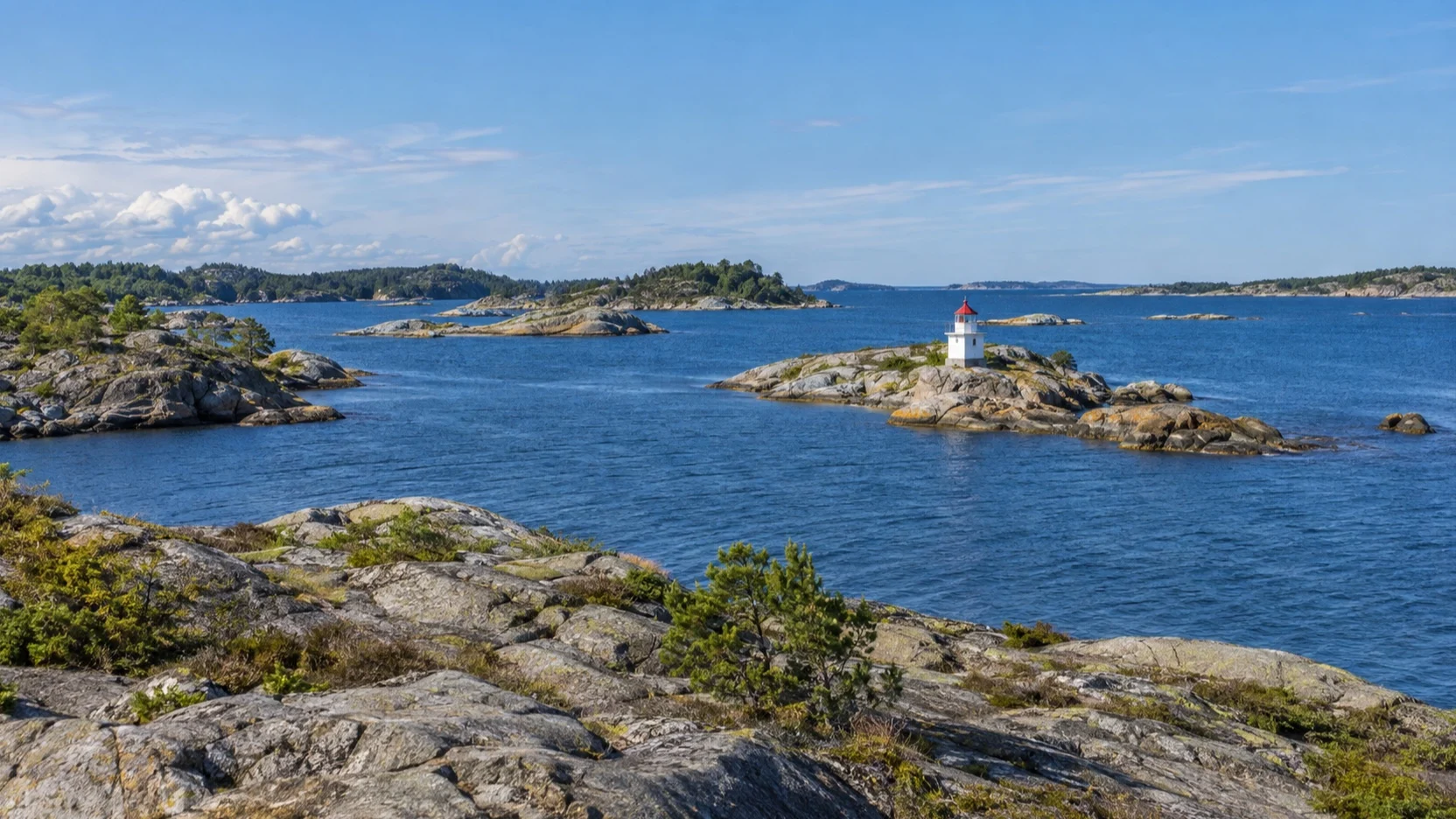 Small lighthouse among rocky skerries off Arendal, Norway
