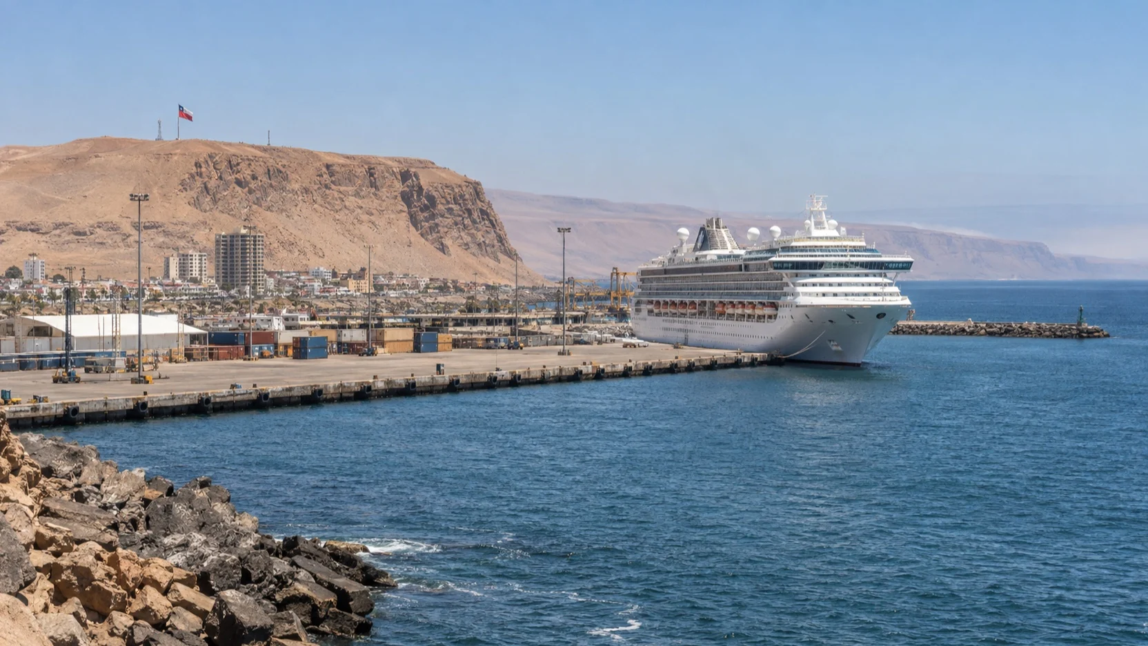 Cruise ship at Arica port below the desert hills of northern Chile