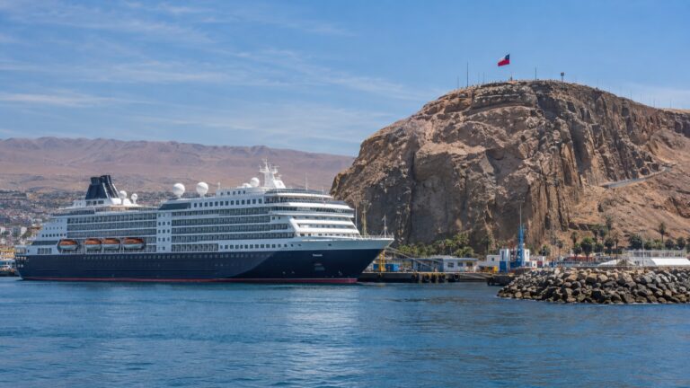A cruise ship in Arica harbor below the rocky Morro de Arica