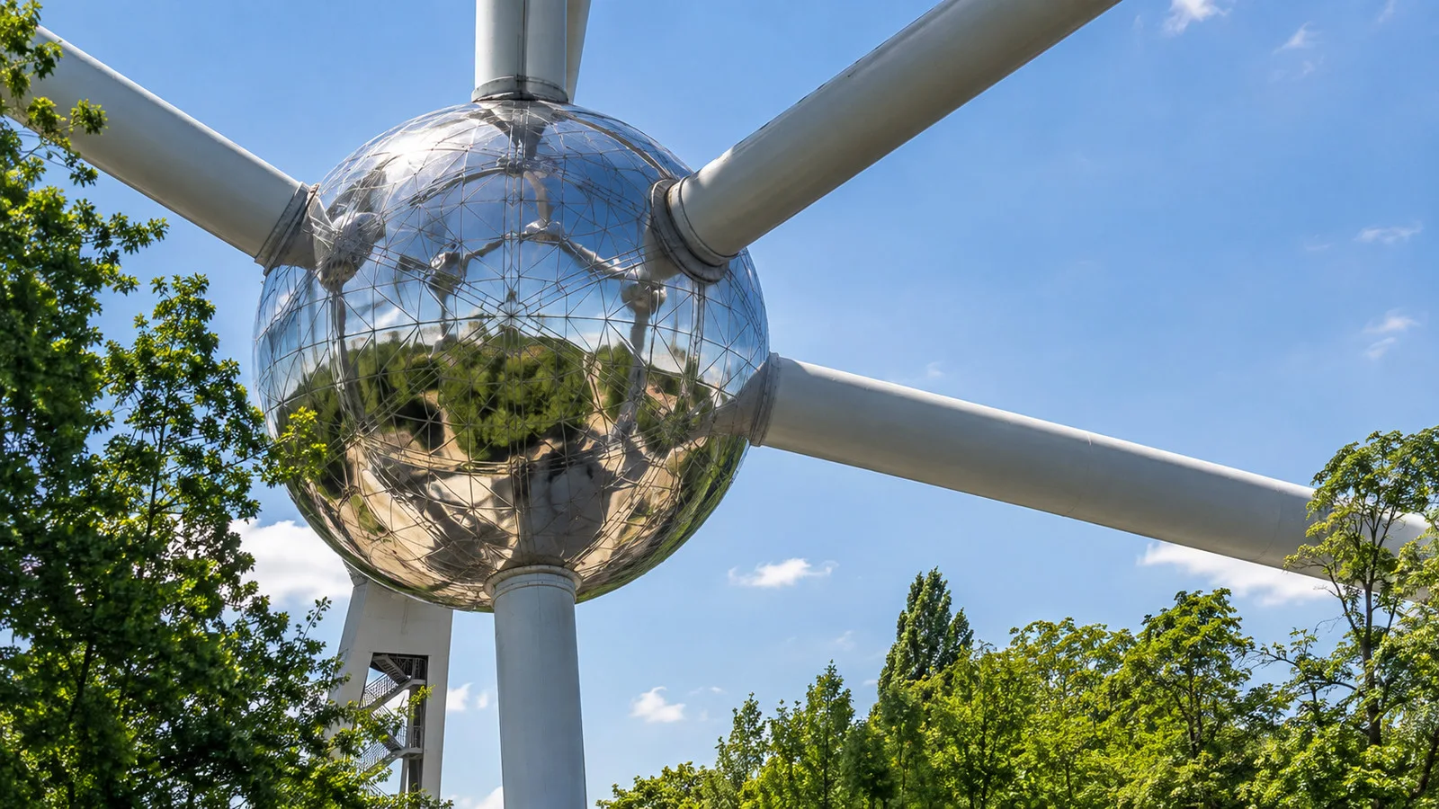 Close view of a reflective Atomium sphere and its connecting tubes in Brussels