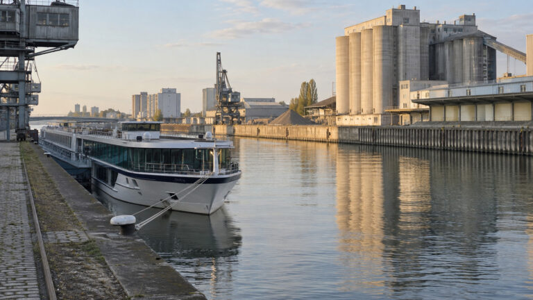 River cruise vessel at an industrial Brussels canal berth