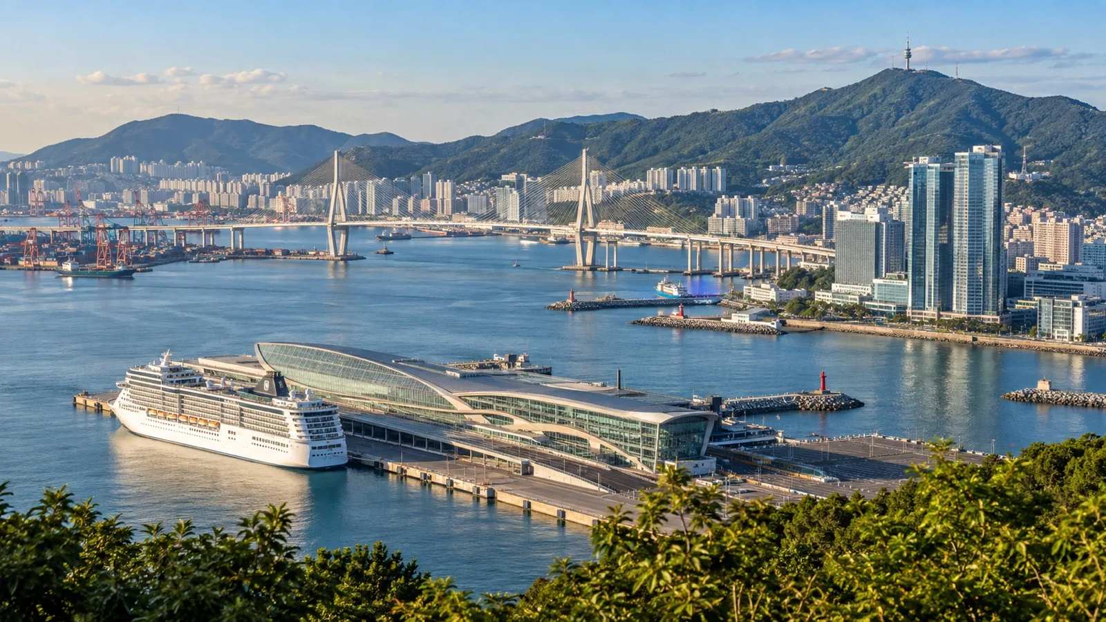 Panoramic Busan harbor showing terminal, bridges, hotels and green coastal hills