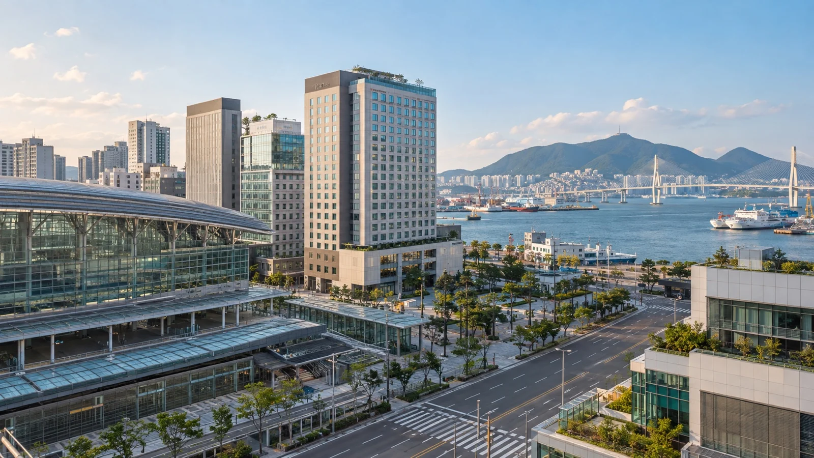 Busan Station district with practical Korean city hotels, clean streets and harbor glimpses