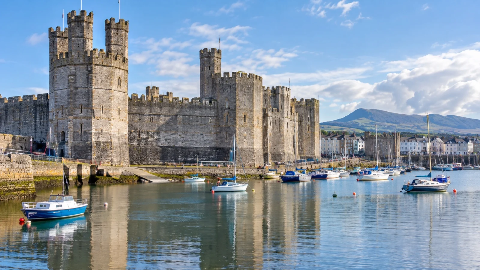 Medieval Caernarfon Castle beside its North Wales harbor