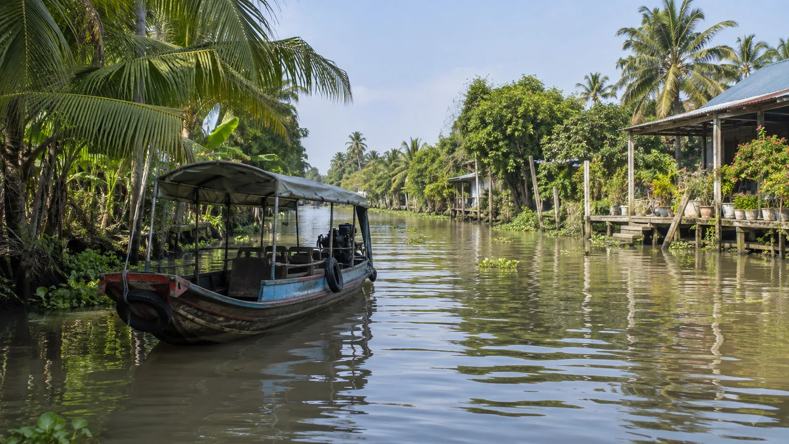 Small passenger boat among Mekong Delta canals near Cái Bè