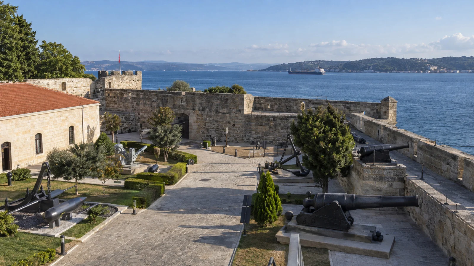 Low stone walls and museum grounds of Çimenlik Castle beside the Dardanelles