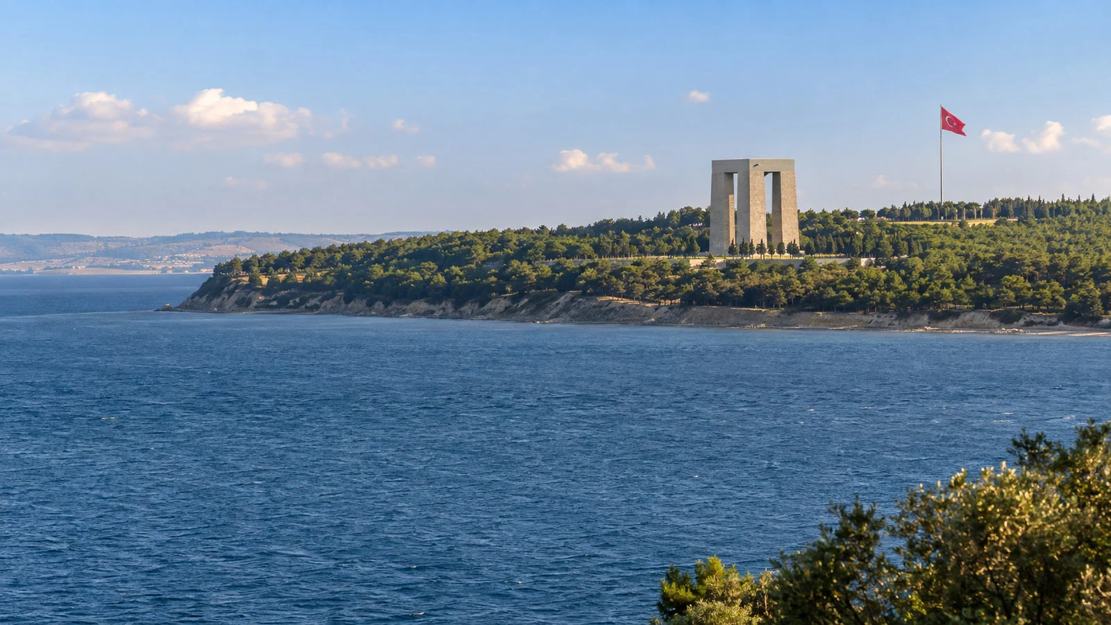 the Gallipoli peninsula coast across the Dardanelles from Çanakkale, with memorial landscape and sea
