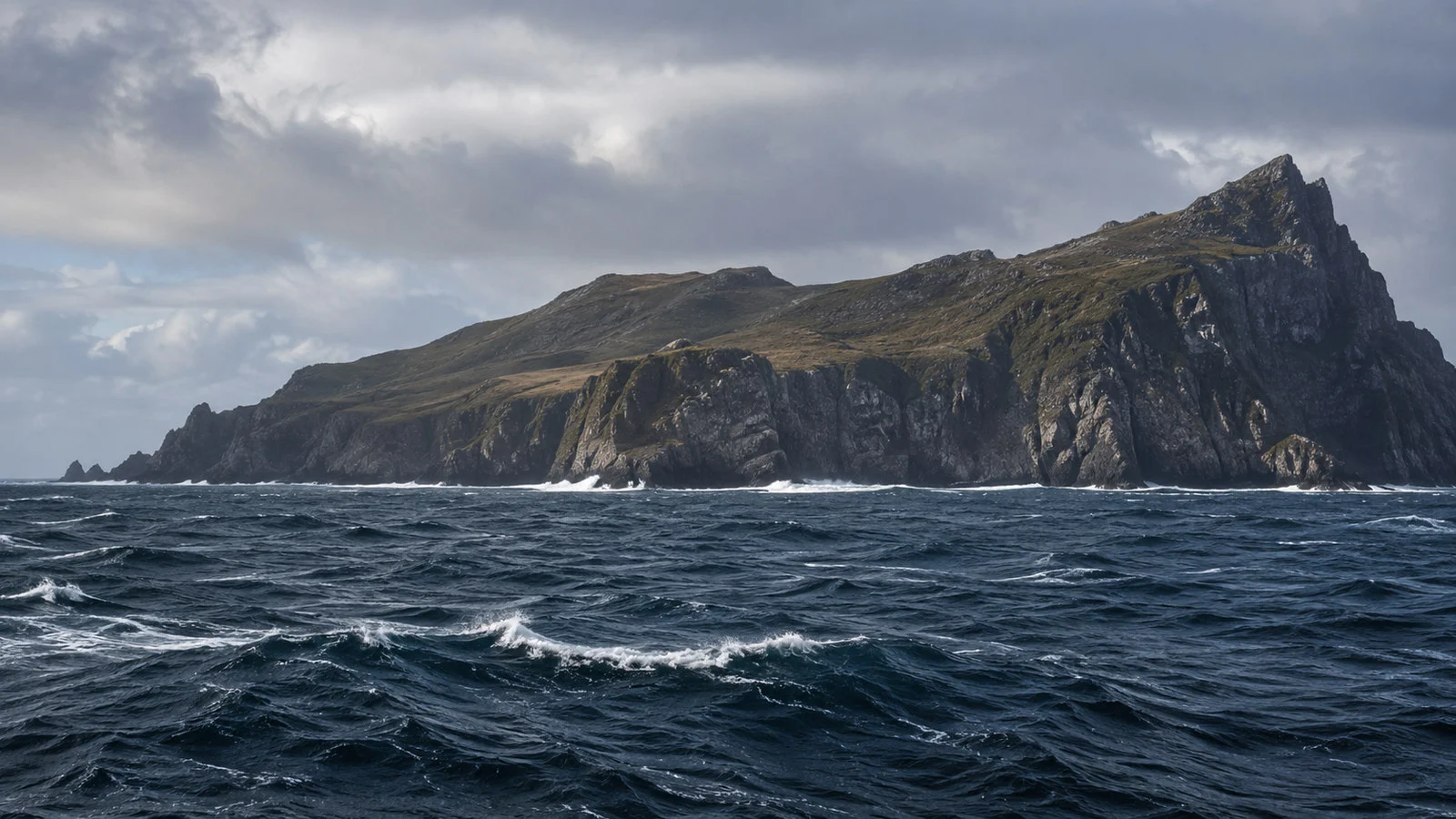Cape Horn Chile dramatic windswept island headland seen from expedition cruise ship at sea with dark Southern Ocean, no people