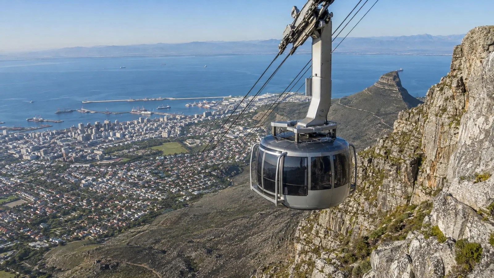 Empty Table Mountain cable car with Cape Town cruise harbor in distance