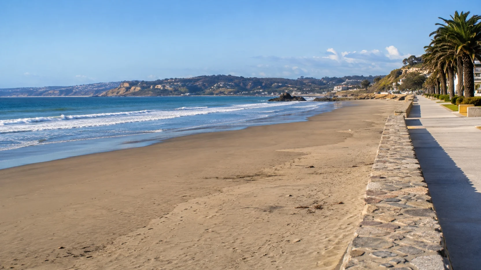 The broad beach and quiet waterfront promenade at Cartagena near San Antonio
