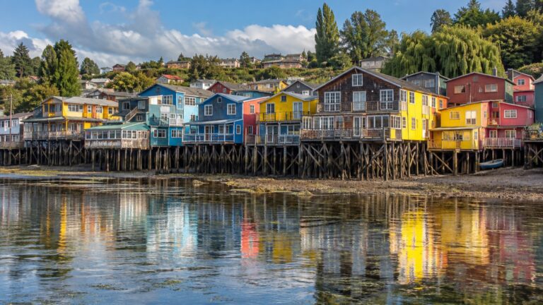 Colorful palafito stilt houses along Castro's tidal waterfront on Chiloé Island