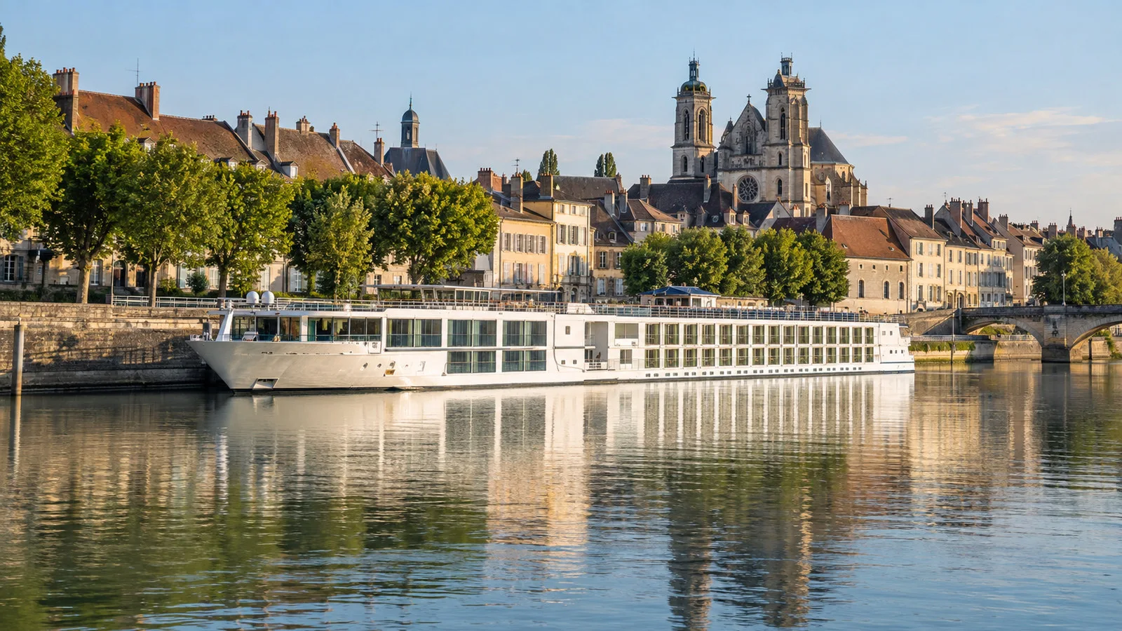 River cruise vessel moored along Saone River waterfront at Chalon-sur-Saone Burgundy France, historic city behind