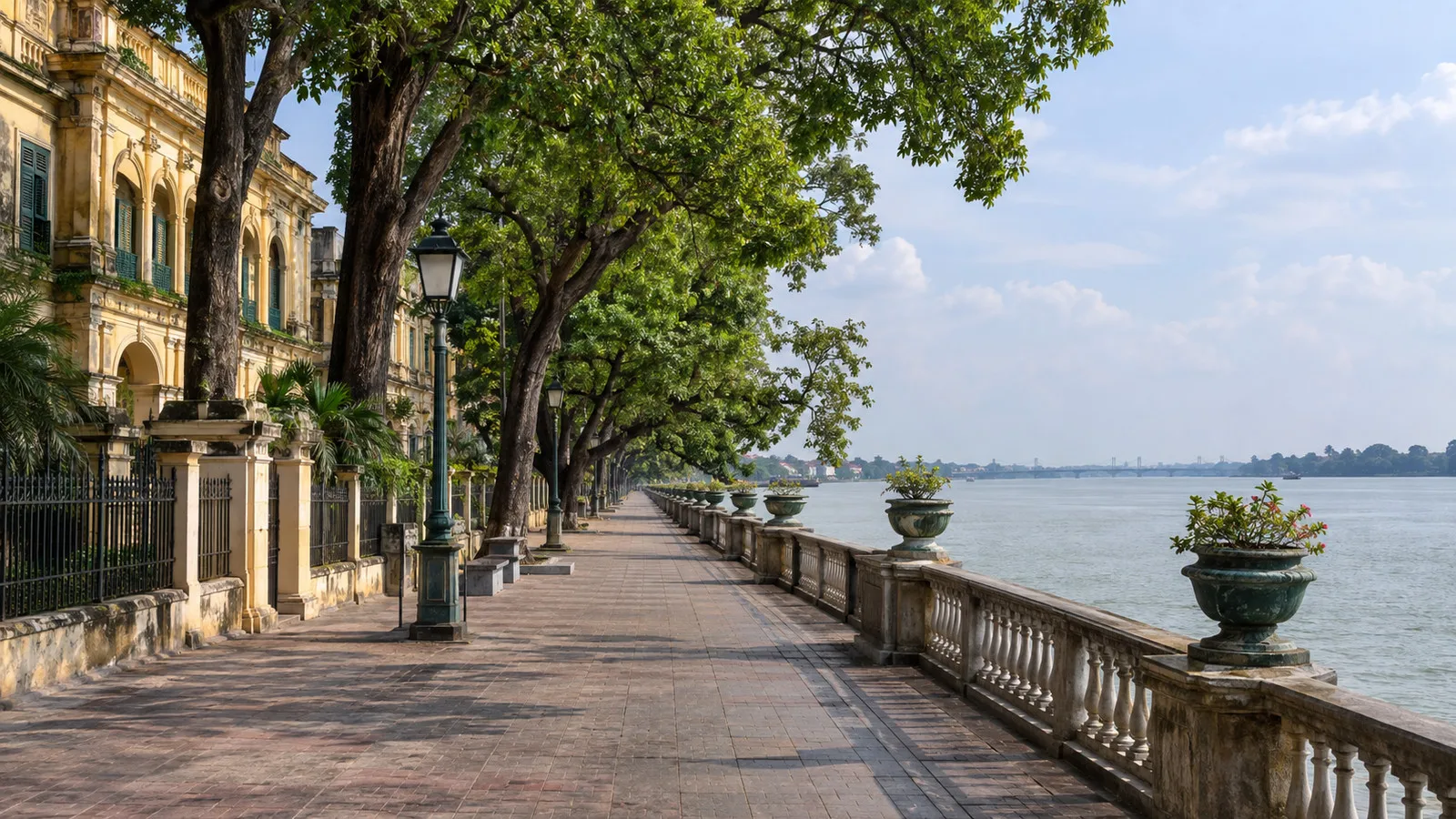 Empty tree-lined Chandannagar Strand promenade with river balustrade and colonial-era buildings