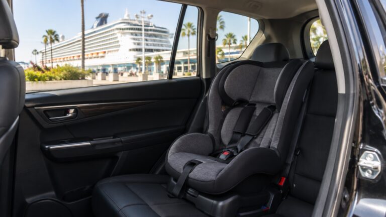 Empty child car seat installed in back of car beside cruise terminal