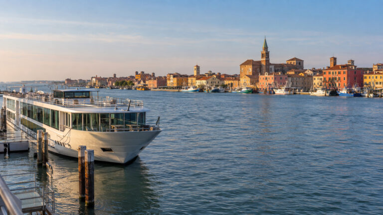 Small river cruise vessel moored on the Chioggia lagoon waterfront