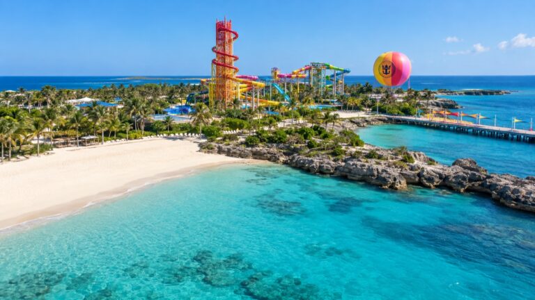 CocoCay's turquoise shore with Thrill Waterpark beyond the beach