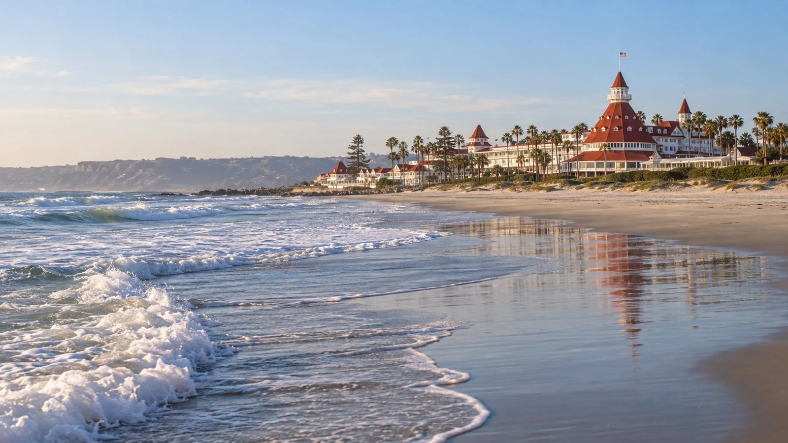 Empty Coronado Beach with the red roofs of Hotel del Coronado beyond the sand