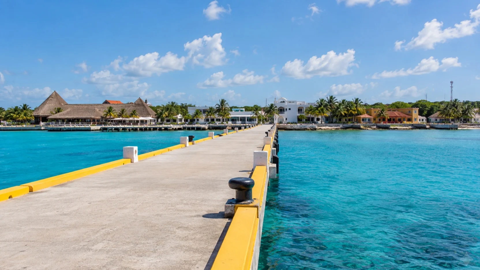Cruise pier extending across turquoise water toward Cozumel’s San Miguel waterfront