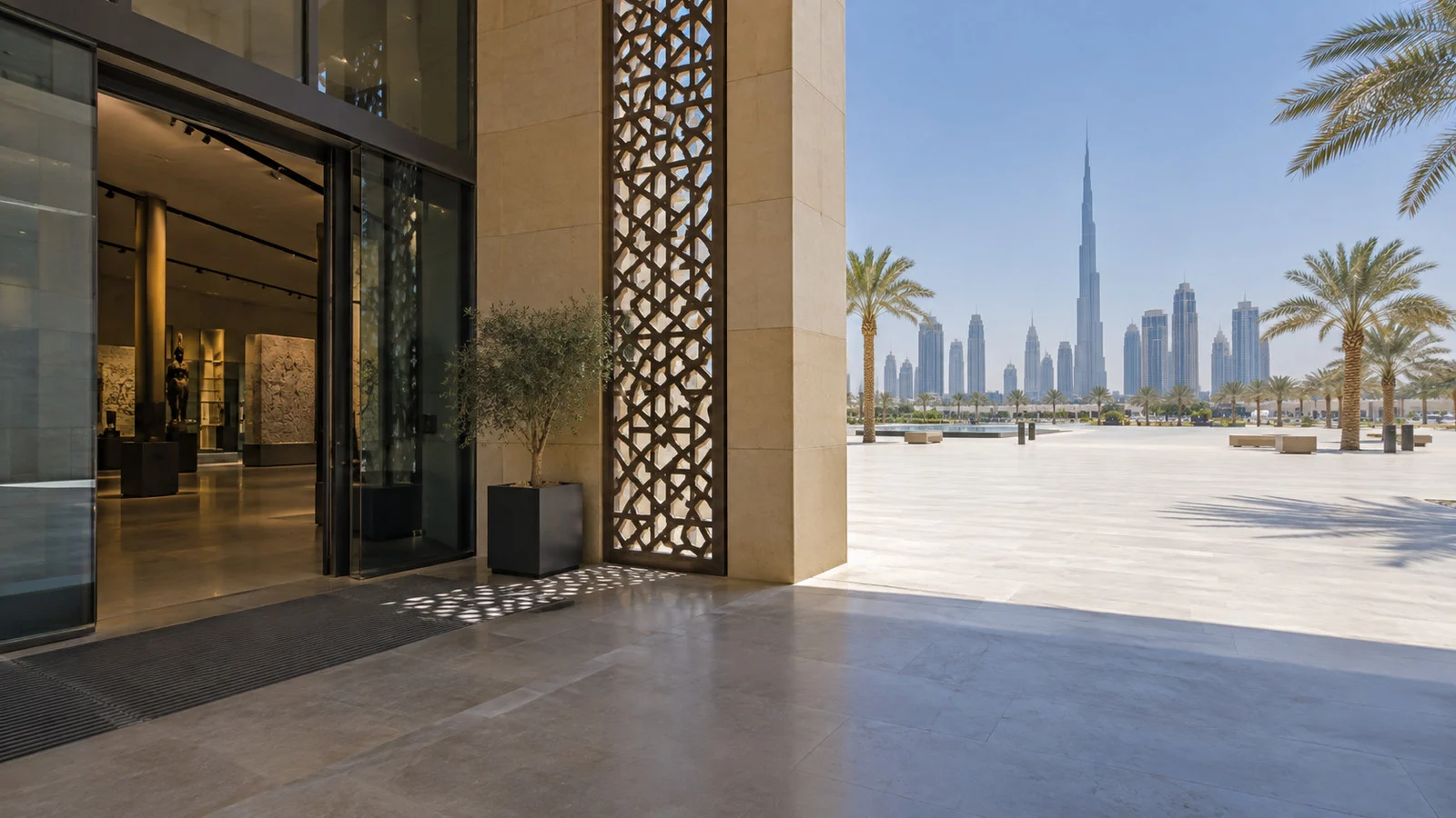 Shaded air-conditioned museum entrance in Dubai beside a hot empty plaza