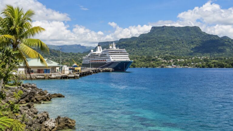 A cruise ship docked at the tropical waterfront in Luganville, Vanuatu