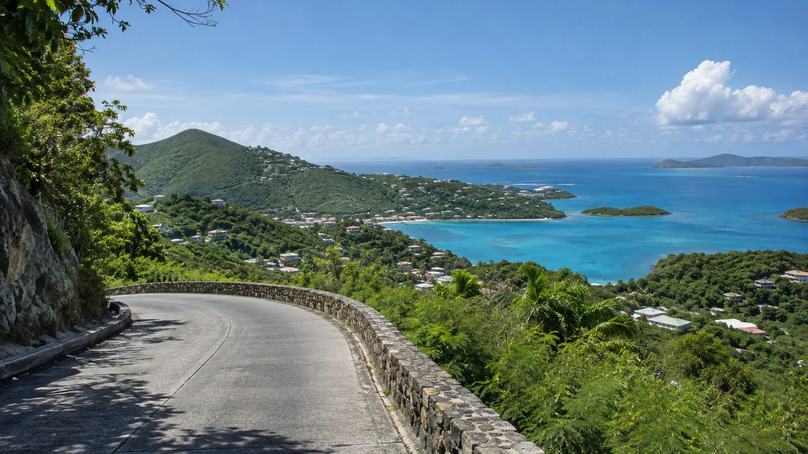 St John island scenic winding road above Cruz Bay with tropical hills and Caribbean sea, no people or vehicles