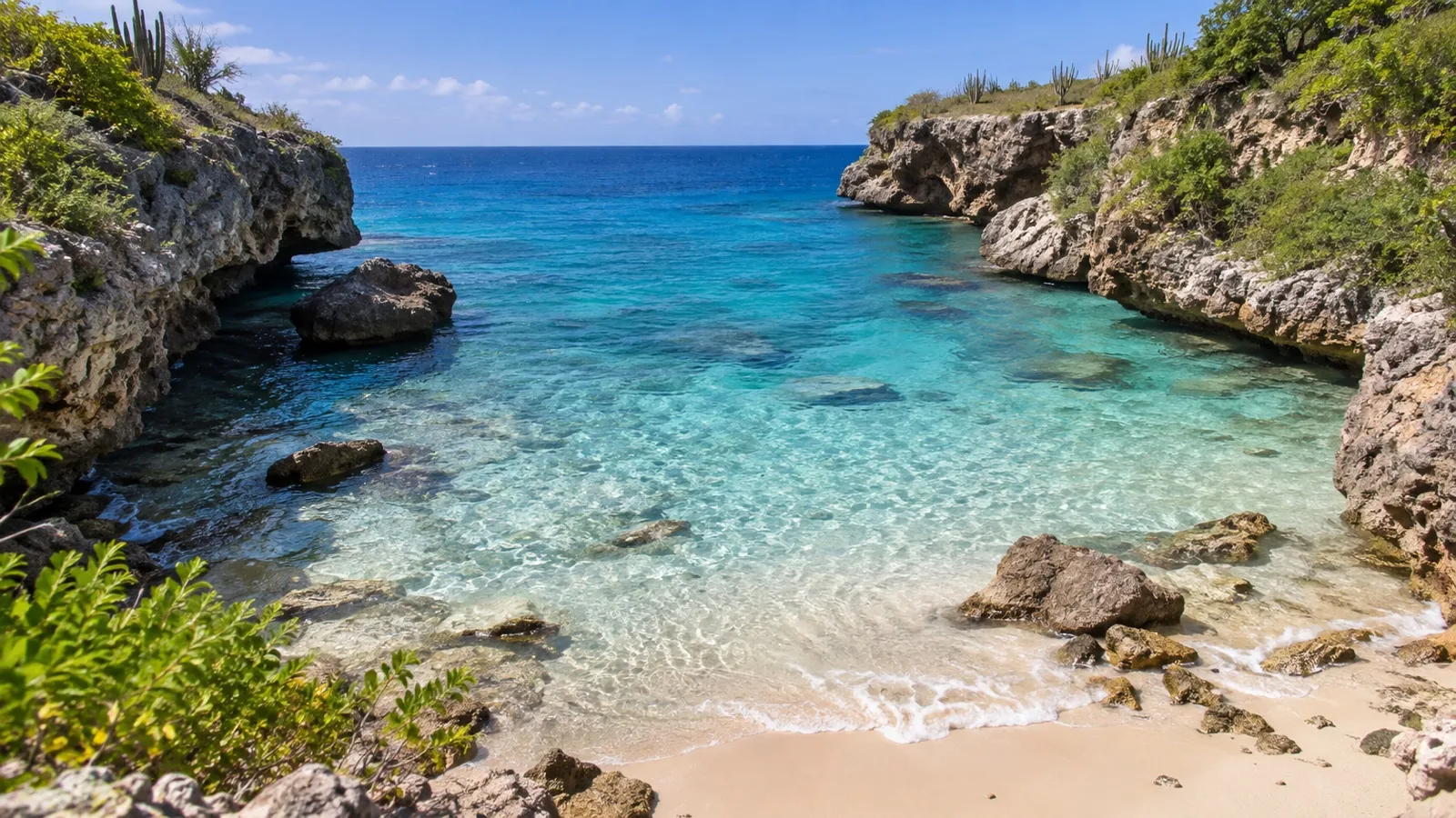 Sheltered rocky cove and clear water at Playa Lagun in Curacao